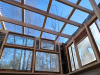 The roof of the greenhouse, clear panels were installed letting the light flow in a warm up the space.