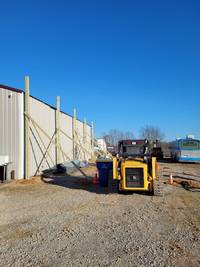 The start of posts being set. Each post was set with cement.