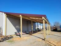 The completion of the project. The customer is now satisfied with ample covered space for storing items out of the weather.
