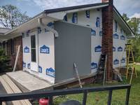 House wrap stapled down and new siding starting to go up